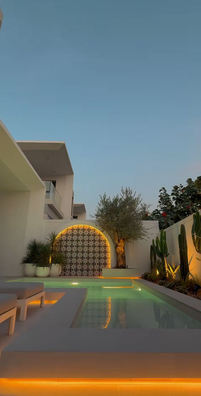 Pool Feature Wall at Dusk &mdash; completed Crownstone villa renovation, Dubai